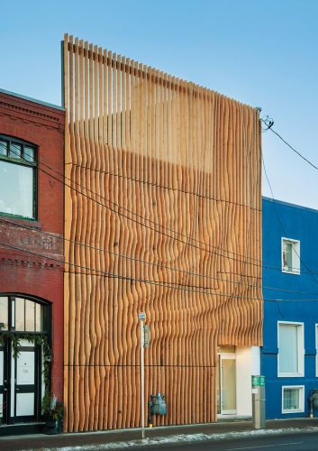 Junction 9 yoga studio was given a fresh look with a shapely screen of vertical fins, made of 100-year-old fir reclaimed from an abandoned Alberta granary. Photo by MHB PHOTO GRAF