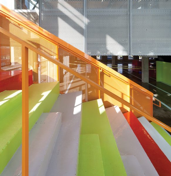 Conceived as an indoor reading garden, a colourful staircase joins the first floor children’s library to the upper floor adult section. Photo: STEVE MONTPETIT