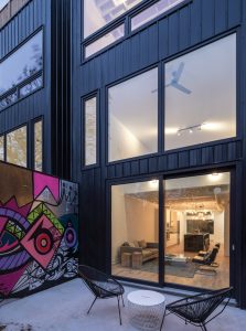 The lower unit’s open floor plate extends between two courtyards and includes loft-like areas at front and back, providing a surprising sense of spaciousness.