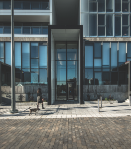 Oversized portals mark building entrances from a street designed to prioritize pedestrian activity over cars.